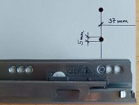 Drawer with clear glass insert between railing and drawer side.